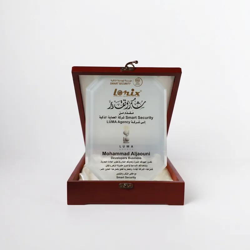 Frosted glass plaque in a wooden presentation box, presented by Smart Security to LUMA Agency.